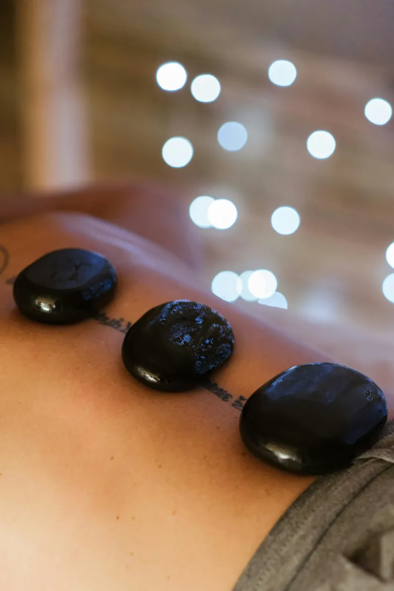 Hot stone massage with smooth heated stones on back